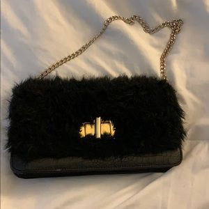 Faux fur and black leather purse.